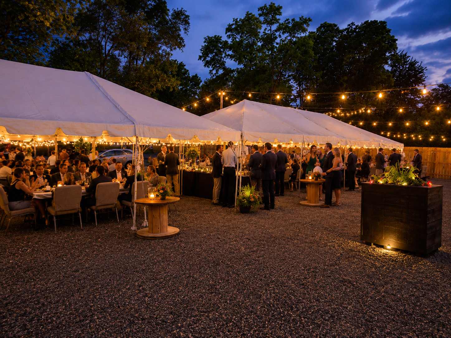 Tented outdoor wedding reception under string lights
