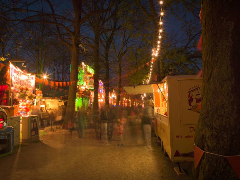 Night carnival with string lights and stalls