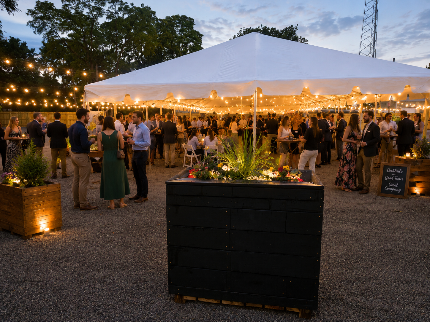 Outdoor evening tented party with string lights