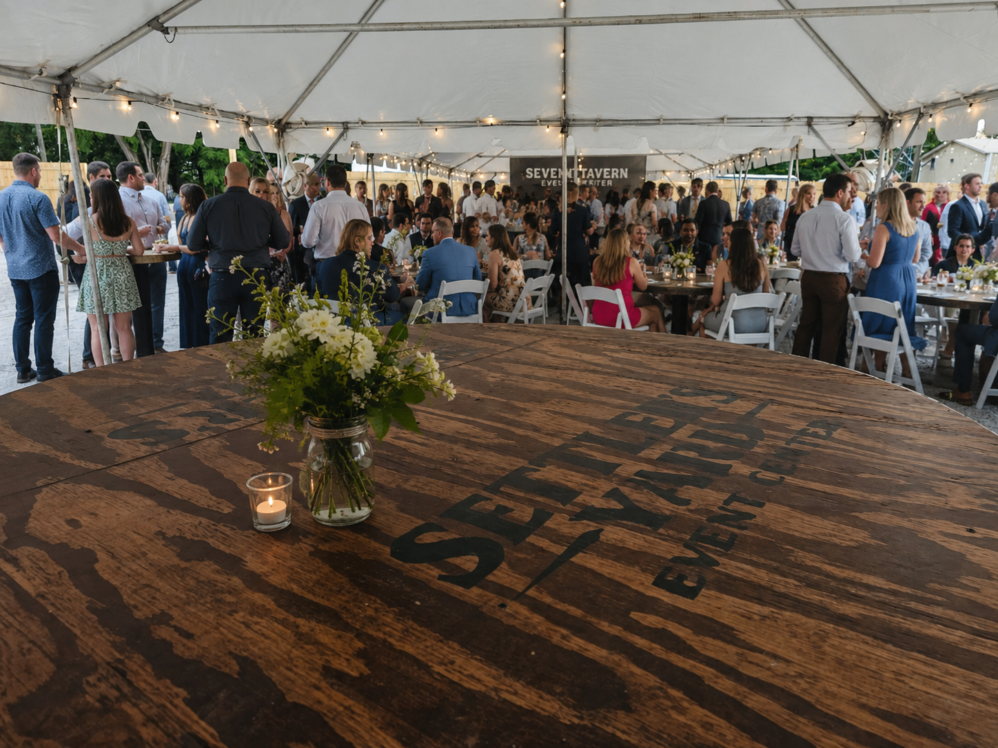Outdoor tented event with seated guests